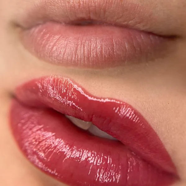 Before and after lip blush result — natural lips to glossy rich red, mouth macro, no identity